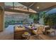 Inviting outdoor patio with comfortable seating, fire pit, and scenic mountain views perfect for relaxing and entertaining at 10271 Meridian Hill Ave, Las Vegas, NV 89135