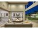 Inviting outdoor patio with comfortable seating, fire pit, and seamless transition to the home's interior dining area at 10271 Meridian Hill Ave, Las Vegas, NV 89135