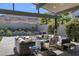 Inviting outdoor patio with comfortable seating, a modern fire pit, and landscaped surroundings at 10271 Meridian Hill Ave, Las Vegas, NV 89135