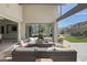 Inviting covered patio boasts stylish seating, a cozy fire pit, and seamless indoor-outdoor living at 10271 Meridian Hill Ave, Las Vegas, NV 89135