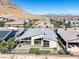 Contemporary rear exterior of home featuring covered patio, outdoor seating area, desert landscaping and mountain views at 10271 Meridian Hill Ave, Las Vegas, NV 89135