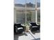 Mountain views in this bright sitting area, featuring two leather chairs, side table, and large windows at 10271 Meridian Hill Ave, Las Vegas, NV 89135