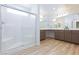 Luxurious bathroom featuring a modern shower and dual vanity sinks at 10631 Sariah Skye Ave, Las Vegas, NV 89166