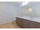 Bathroom features double sinks, quartz countertops, modern fixtures, and sleek white tiles at 10631 Sariah Skye Ave, Las Vegas, NV 89166