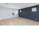 Modern bedroom with stylish accent wall, natural light, and wood-look floors at 10631 Sariah Skye Ave, Las Vegas, NV 89166