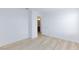 Bright bedroom with wood flooring, white walls, and open doorway to bathroom at 10631 Sariah Skye Ave, Las Vegas, NV 89166