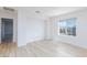 Bright bedroom showcasing wood-look floors and a view of the neighborhood at 10631 Sariah Skye Ave, Las Vegas, NV 89166