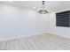 Open living space features luxury vinyl floors, recessed lighting, and modern chandelier at 10631 Sariah Skye Ave, Las Vegas, NV 89166