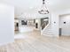 Open concept living space with luxury vinyl floors connects kitchen, stairs, and living room at 10631 Sariah Skye Ave, Las Vegas, NV 89166