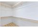 Spacious walk-in closet with wood flooring and shelving, perfect for organization at 10631 Sariah Skye Ave, Las Vegas, NV 89166