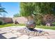 Landscaped backyard featuring a fire pit and custom fountain, and desert landscaping at 1072 Pennyfeather Rd, Henderson, NV 89015