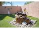 Backyard featuring desert landscaping and a custom rock fountain at 1072 Pennyfeather Rd, Henderson, NV 89015