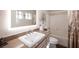 Modern bathroom with a granite vanity, illuminated mirror, and a shower-tub combination for convenience at 1072 Pennyfeather Rd, Henderson, NV 89015