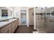 Bathroom features double sinks, quartz countertops and walk-in shower at 1072 Pennyfeather Rd, Henderson, NV 89015