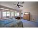 Bright bedroom with bay window seating, ceiling fan and dresser at 1072 Pennyfeather Rd, Henderson, NV 89015
