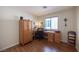Cozy bedroom with wood floors, a window with shutters, and ample storage space with a wardrobe at 1072 Pennyfeather Rd, Henderson, NV 89015