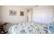 Comfortable bedroom with a quilted bedspread, closet, and side table, offering a serene retreat at 1072 Pennyfeather Rd, Henderson, NV 89015