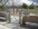 View of a small dog park area with shade trees and seating at 1072 Pennyfeather Rd, Henderson, NV 89015