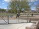View of a large dog park area with shade trees and seating at 1072 Pennyfeather Rd, Henderson, NV 89015