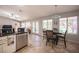 Open kitchen and dining area with backyard views, stainless steel appliances, and tile flooring at 1072 Pennyfeather Rd, Henderson, NV 89015