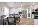 Bright kitchen with a dining area featuring stainless steel appliances and a view of the backyard at 1072 Pennyfeather Rd, Henderson, NV 89015