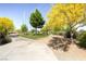 Beautifully landscaped walkway with mature shade trees and desert landscaping at 1072 Pennyfeather Rd, Henderson, NV 89015