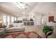 Spacious living room featuring tile floors, vaulted ceilings, and seamless connection to the kitchen area at 1072 Pennyfeather Rd, Henderson, NV 89015