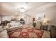Open-concept living room with tile floors, vaulted ceilings, and a dining area in the background at 1072 Pennyfeather Rd, Henderson, NV 89015