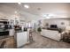 Cozy living room with white sofa and stainless steel appliances and tile floors at 1072 Pennyfeather Rd, Henderson, NV 89015