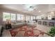 Open-concept living room with tile floors, vaulted ceilings, a ceiling fan, and a breakfast bar at 1072 Pennyfeather Rd, Henderson, NV 89015