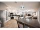 Open-concept living room and kitchen area with modern decor and lots of natural light at 1072 Pennyfeather Rd, Henderson, NV 89015