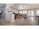 Bright living room featuring tile floors, vaulted ceilings, a ceiling fan, and a cozy seating arrangement at 1072 Pennyfeather Rd, Henderson, NV 89015