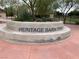 Heritage Bark Park entrance sign surrounded by landscaping and walking paths at 1072 Pennyfeather Rd, Henderson, NV 89015