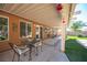 Covered patio with table and chairs with access to backyard at 1072 Pennyfeather Rd, Henderson, NV 89015