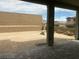 A vacant backyard space surrounded by brick walls with a covered patio in view at 12434 Parkscene Pl, Las Vegas, NV 89138