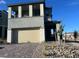 Two-story home with a two-car garage, porch, and balcony on a sunny day at 12434 Parkscene Pl, Las Vegas, NV 89138