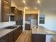 Well-lit kitchen with stainless steel appliances, granite countertops, and wooden floors at 12434 Parkscene Pl, Las Vegas, NV 89138
