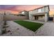 Backyard features turf and a patio, enclosed with a block wall for privacy at 12457 Sunset Sage Ave, Las Vegas, NV 89138