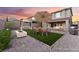Backyard with turf and patio areas, swing, fire pit, outdoor dining table and outdoor sofas at 12457 Sunset Sage Ave, Las Vegas, NV 89138