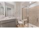 Modern bathroom featuring a glass-enclosed shower, white fixtures, and neutral tile at 12457 Sunset Sage Ave, Las Vegas, NV 89138