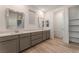 Bright bathroom features a double vanity, wood flooring, and walk-in closet at 12457 Sunset Sage Ave, Las Vegas, NV 89138