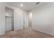 Bright bedroom with neutral carpet, closet with sliding doors, and an ensuite bathroom at 12457 Sunset Sage Ave, Las Vegas, NV 89138