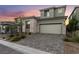 Beautiful two-story home featuring stone accents and a spacious two-car garage and a beautiful brick driveway at 12457 Sunset Sage Ave, Las Vegas, NV 89138