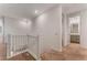 Upstairs hallway featuring a white railing with gray carpet, bright walls and a bathroom view at 12457 Sunset Sage Ave, Las Vegas, NV 89138