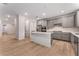 Modern kitchen with stainless appliances, island, and large pantry at 12457 Sunset Sage Ave, Las Vegas, NV 89138