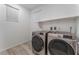 Convenient laundry room with modern washer and dryer units, plus a storage shelf above at 12457 Sunset Sage Ave, Las Vegas, NV 89138