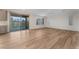 Living area with wood flooring, sliding glass doors and window shutters at 12457 Sunset Sage Ave, Las Vegas, NV 89138