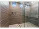 Large glass shower featuring tiled walls, dual shower heads, and white tiled floor at 12457 Sunset Sage Ave, Las Vegas, NV 89138