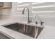 Modern kitchen sink with stainless steel fixtures and white marble countertops, complemented by bright natural light at 12457 Sunset Sage Ave, Las Vegas, NV 89138