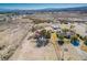 An aerial view shows the home, desert landscape, and the mountains in the background at 1967 N Moapa Valley Blvd, Logandale, NV 89021